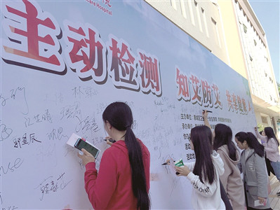     在艾滋病防治科普宣传活动中，大学生签名承诺主动防艾。 本报记者周 楠 摄